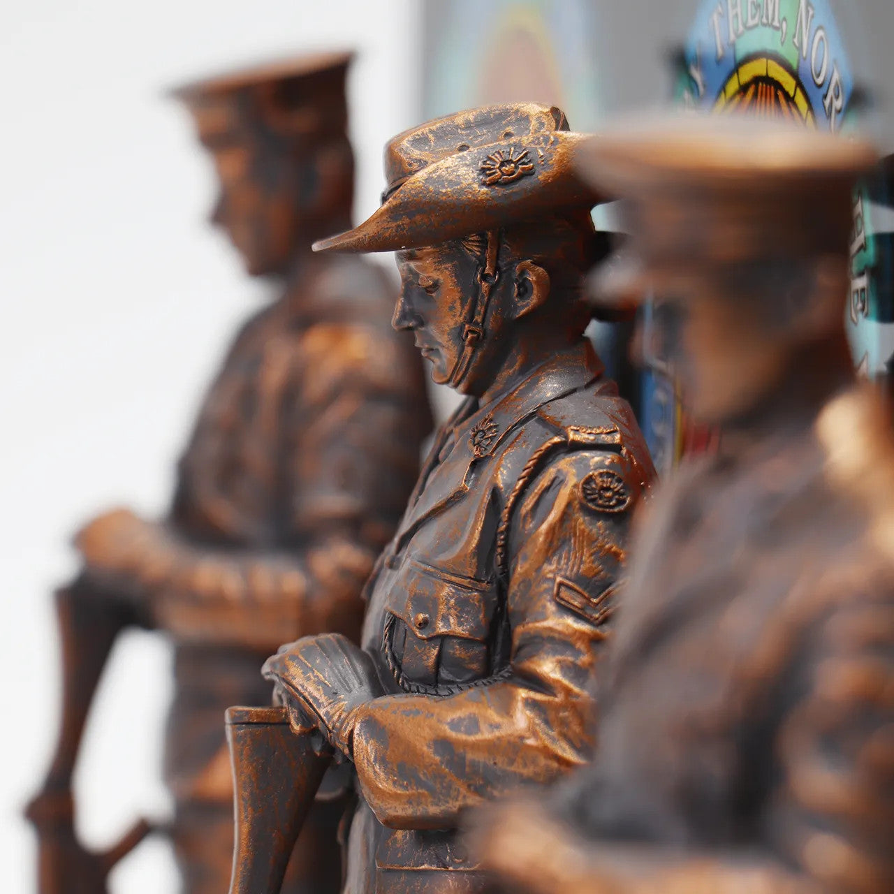 This stunning Courage, Honour, Sacrifice: We Will Remember Them* figurine is a remarkable tribute, crafted with exquisite attention to detail. The figurines, made from cold cast bronze, beautifully depict personnel from the Royal Australian Navy, Australian Army, and Royal Australian Air Force, all captured in a solemn Resting on Reversed Arms stance. www.defenceqstore.com.au