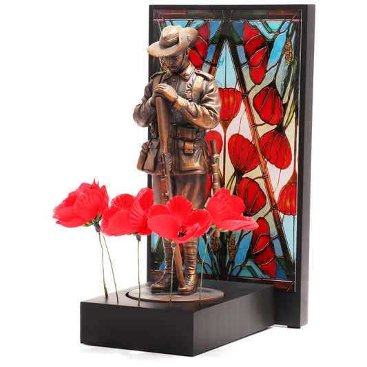 This beautifully crafted miniature figurine is a poignant tribute to our fallen soldiers. It comes with a striking acrylic backdrop, featuring an intricate stained-glass poppy design that adds depth and significance to the piece. www.defenceqstore.com.au