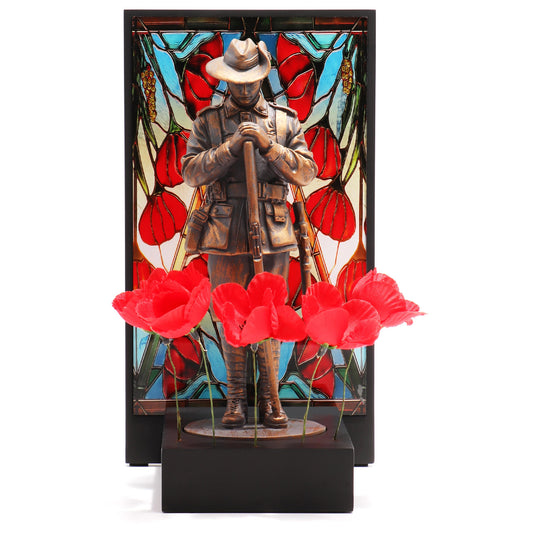 This beautifully crafted miniature figurine is a poignant tribute to our fallen soldiers. It comes with a striking acrylic backdrop, featuring an intricate stained-glass poppy design that adds depth and significance to the piece. www.defenceqstore.com.au