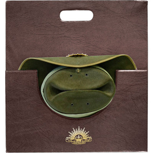 This slouch hat carrier is the perfect travel accessory to ensure your hat stays in perfect condition.  Keep your hat in great shape with this quality dark brown leather-look slouch hat carrier.  Heavy duty card covered with heat sealed PVC. A gold printed Rising Sun completes this item. www.defenceqstore.com.au