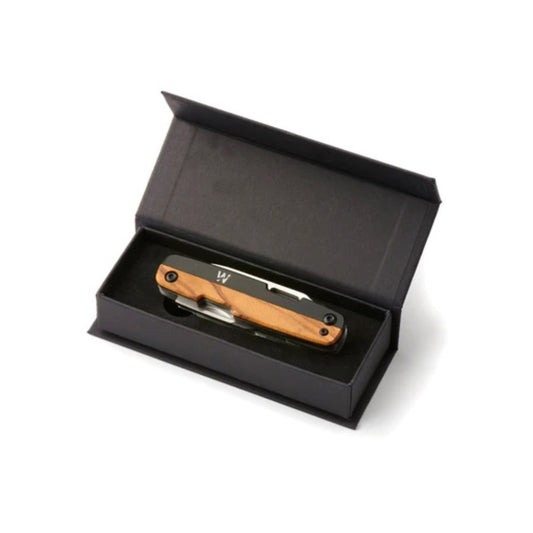 This versatile EDC knife features a plain blade with a convenient finger hole, complemented by a flat head screwdriver, scissors, and a Phillips screwdriver with a cap lifter. Crafted with a black and olive wood handle and a 5.7 cm 12CR27 steel blade, it offers durability and style. Compact at 8.75 cm closed length and weighing just 108g, it’s perfect for everyday carry. Presented in a premium card gift box, it makes an excellent gift for practical use. www.defenceqstore.com.au