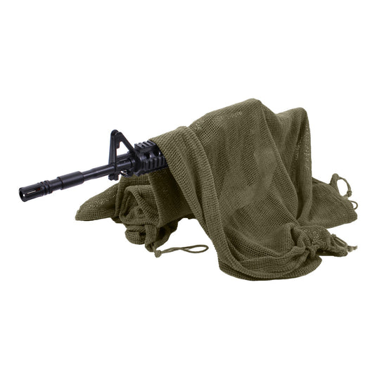 Rothco's Sniper Veil provides the perfect concealment for a sniper and their weapon. The veil measures 36" x 46" with a cinch cord running all 4 sides and cord loop at each corner that would allow you to utilize the veil as a gear hammock to keep objects off the ground or secure the veil to the body or gear. In addition to the veil concealing a weapon, it can be worn as a shemagh or scarf to protect the body from the elements.