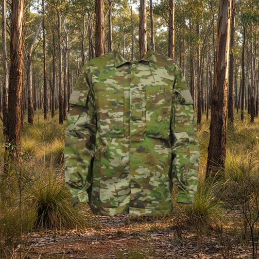 Built for demanding conditions, this TAS Long Sleeve Military Cadet shirt combines authentic Australian Army camouflage with practical performance features. The robust 70% cotton and 30% polyester blend delivers superior breathability without sacrificing durability, while the substantial 270GSM fabric stands up to rigorous wear. www.defenceqstore.com.au