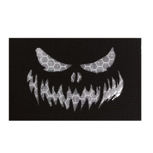 Stand out in low-light conditions with this striking Haunting Laser Cut Reflective Patch Hook &amp; Loop. Precision laser-cut design delivers crisp, detailed edges that catch the eye, while the reflective feature ensures visibility when it matters most.  www.defenceqstore.com.au