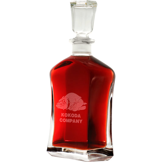 Bring your dining experience to life with the Kokoda Company Italian Glass Decanter. This elegant, 750ml decanter proudly displays the company crest, etched with precision onto the sleek glass surface. Perfect for gifting or displaying in your own cabinet or bar, this decanter is a must-have for any wine or spirit enthusiast. Enhance your evening with the beauty and quality of this stunning piece. www.defenceqstore.com.au