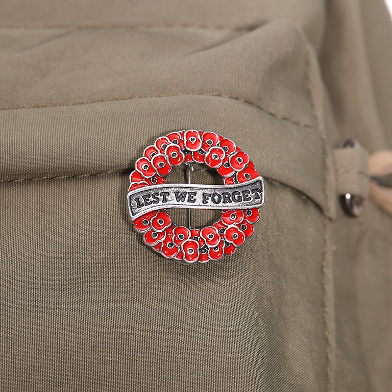 Honour the fallen with the Lest We Forget Poppy Wreath Gold Front Brooch—a striking tribute that blends timeless remembrance with contemporary style. This exquisite 28mm brooch features a multi-dimensional design with deep translucent red petals set against luxurious gold plating, creating a piece that commands attention and respect. www.defenceqstore.com.au