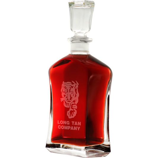 Bring your dining experience to life with the Long Tan Company Italian Glass Decanter. This elegant, 750ml decanter proudly displays the company crest, etched with precision onto the sleek glass surface. Perfect for gifting or displaying in your own cabinet or bar, this decanter is a must-have for any wine or spirit enthusiast. Enhance your evening with the beauty and quality of this stunning piece. www.defenceqstore.com.au