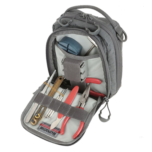 The AUP Accordion Utility Pouch is a small pouch with accordion style dividers. It has a frontal zippered compartment with elastic organization and a top carry handle made from comfortable Shapeshift webbing. www.defenceqstore.com.au