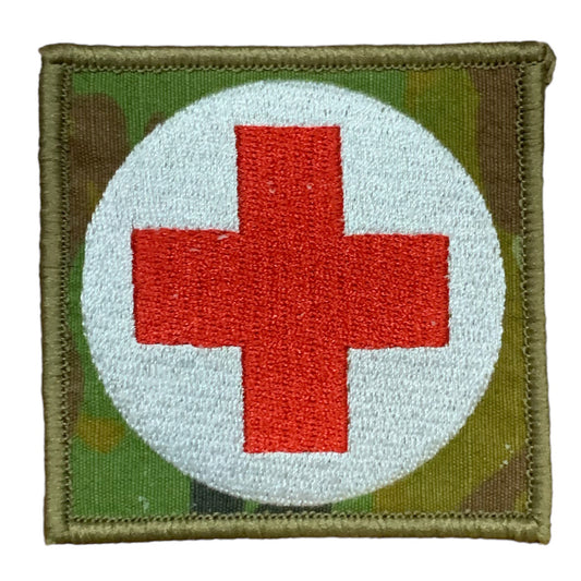 This Military Combat Patch, with the option of Plain or Velcro backing, is an essential for First Aid personnel in the field. Made from high-quality materials, this patch features an Australian-made field medical symbol and can easily be attached to First Aid Kits, Packs, or arm bands. Its exceptional quality is evident with overlocked edges and a size of 65mm x 65mm. Plus, it's proudly made in Australia using AMC Fabric. www.defenceqstore.com.au