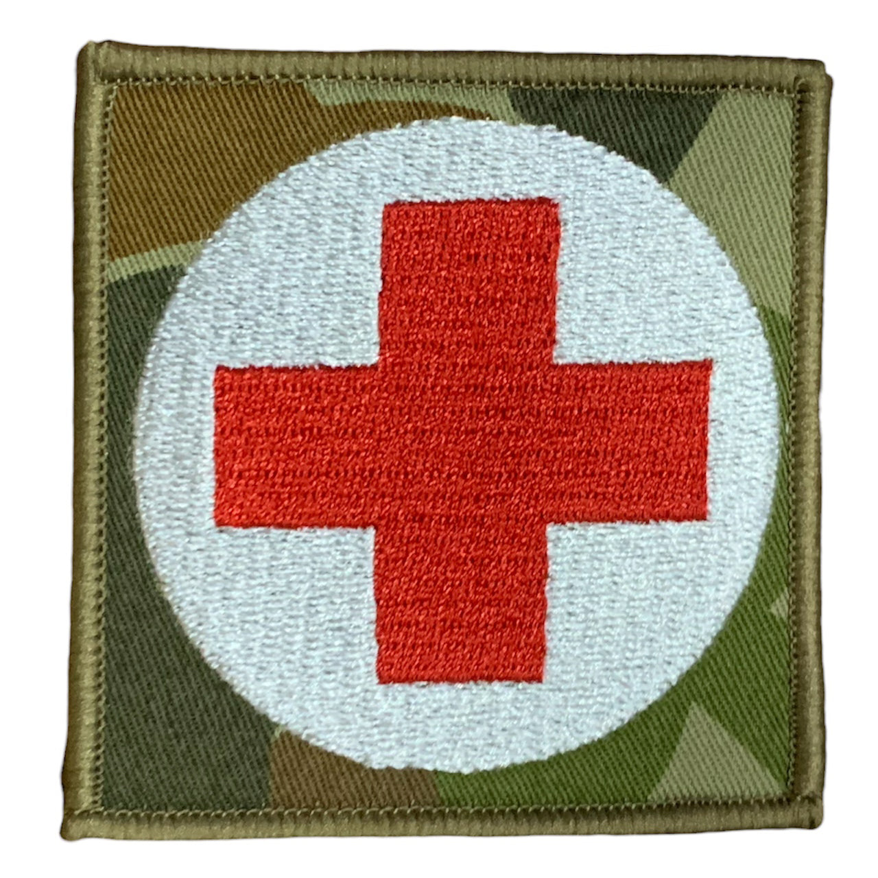 This Military Combat Patch, with the option of Plain or Velcro backing, is an essential for First Aid personnel in the field. Made from high-quality materials, this patch features an Australian-made field medical symbol and can easily be attached to First Aid Kits, Packs, or arm bands. Its exceptional quality is evident with overlocked edges and a size of 65mm x 65mm. Plus, it's proudly made in Australia using Auscam Fabric. www.defenceqstore.com.au