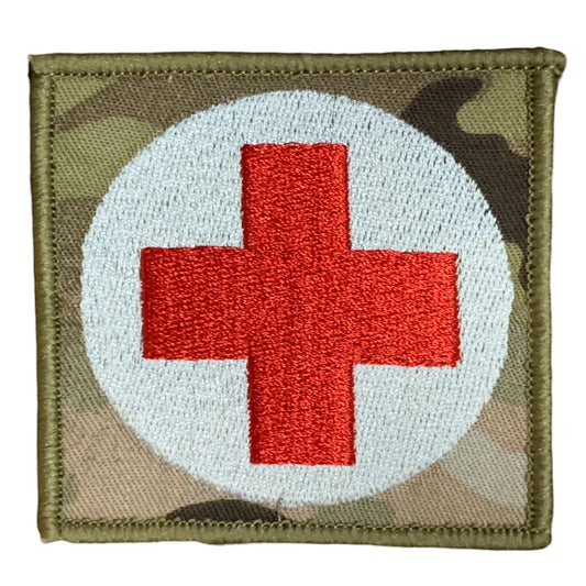 This Military Combat Patch, with the option of Plain or Velcro backing, is an essential for First Aid personnel in the field. Made from high-quality materials, this patch features an Australian-made field medical symbol and can easily be attached to First Aid Kits, Packs, or arm bands. Its exceptional quality is evident with overlocked edges and a size of 65mm x 65mm. Plus, it's proudly made in Australia using Multicam Fabric. www.defenceqstore.com.au