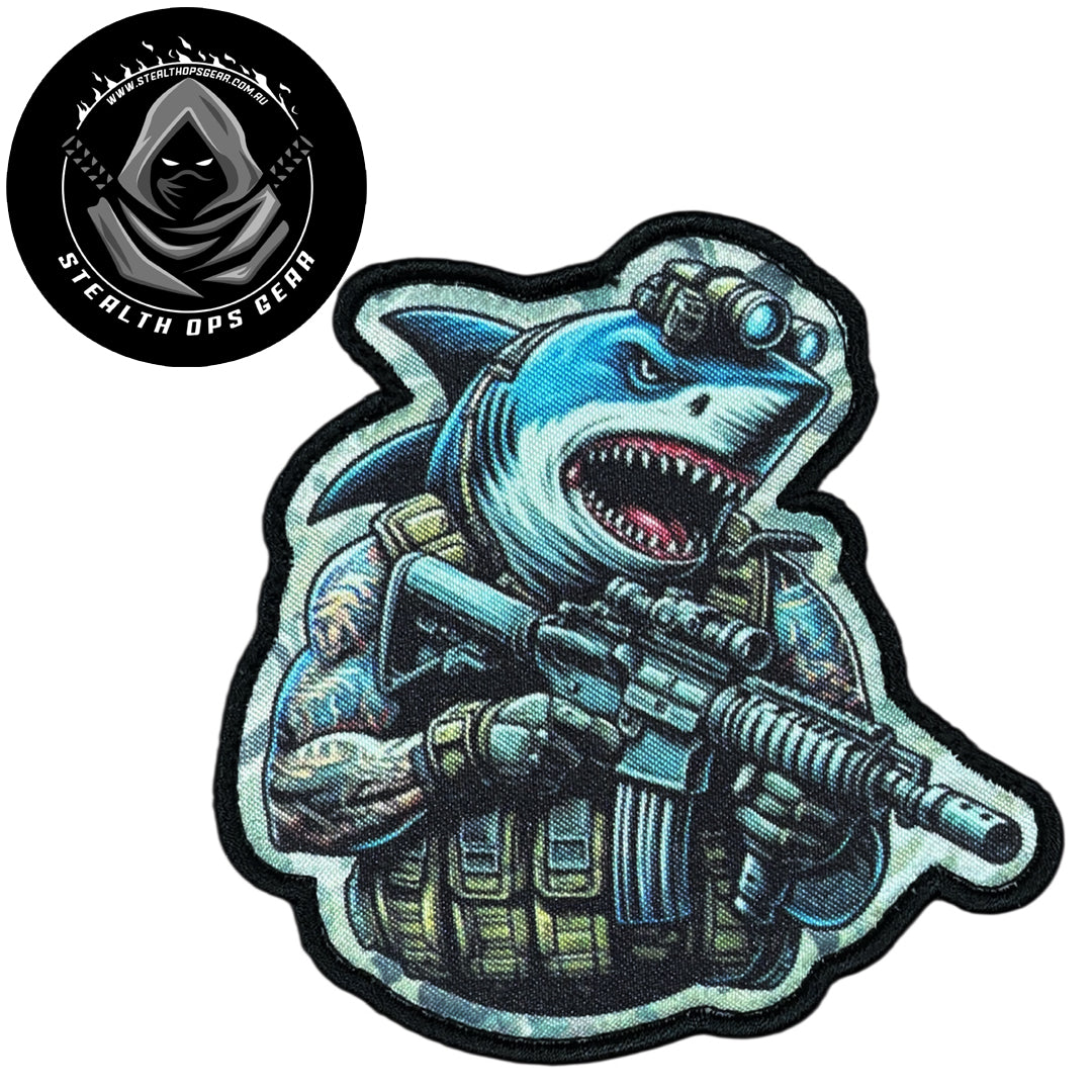 Unleash your creativity with the Shark Assault Embroidery Patch Hook &amp; Loop Stealth Ops Gear! Measuring 9x8.8cm and featuring a beautifully embroidered design and secure hook &amp; loop backing, this patch is a must-have for any collector. www.defenceqstore.com.au