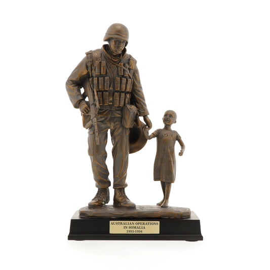 The Somalia Figurine is a sensational keepsake that pays tribute to the brave men and women who served our nation in Somalia. Inspired by Gary Ramage's iconic photograph, this figurine depicts a soldier helping a young girl, symbolizing the spirit of service and humanity. Standing at 30cm tall, this superb figurine is the perfect gift or collectable. www.defenceqstore.com.au