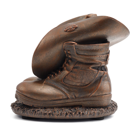 This Miniature Stand Down Figurine is the perfect present for serving members or veterans. This cold-cast bronze figurine depicts a soldier's slouch hat placed on his combat boots at the end of a long day. www.defenceqstore.com.au