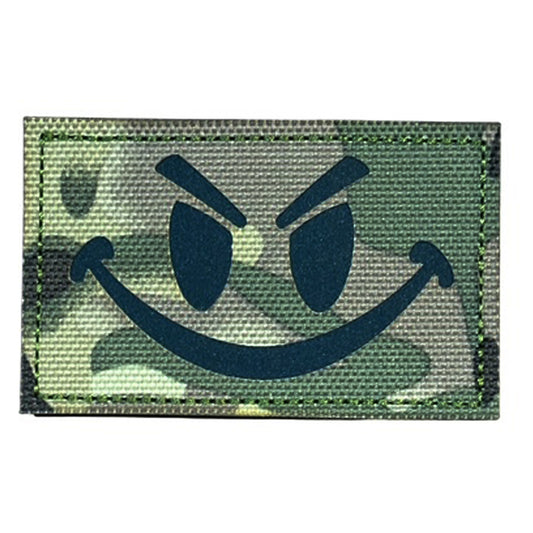 Make a bold statement with the Evil Smile Laser Cut Multicam Patch. This striking 8x5cm patch features laser-cut precision detailing that demands attention. Backed with both hook and loop fasteners, it's ready to attach to tactical gear, backpacks, or uniforms instantly. www.defenceqstore.com.au