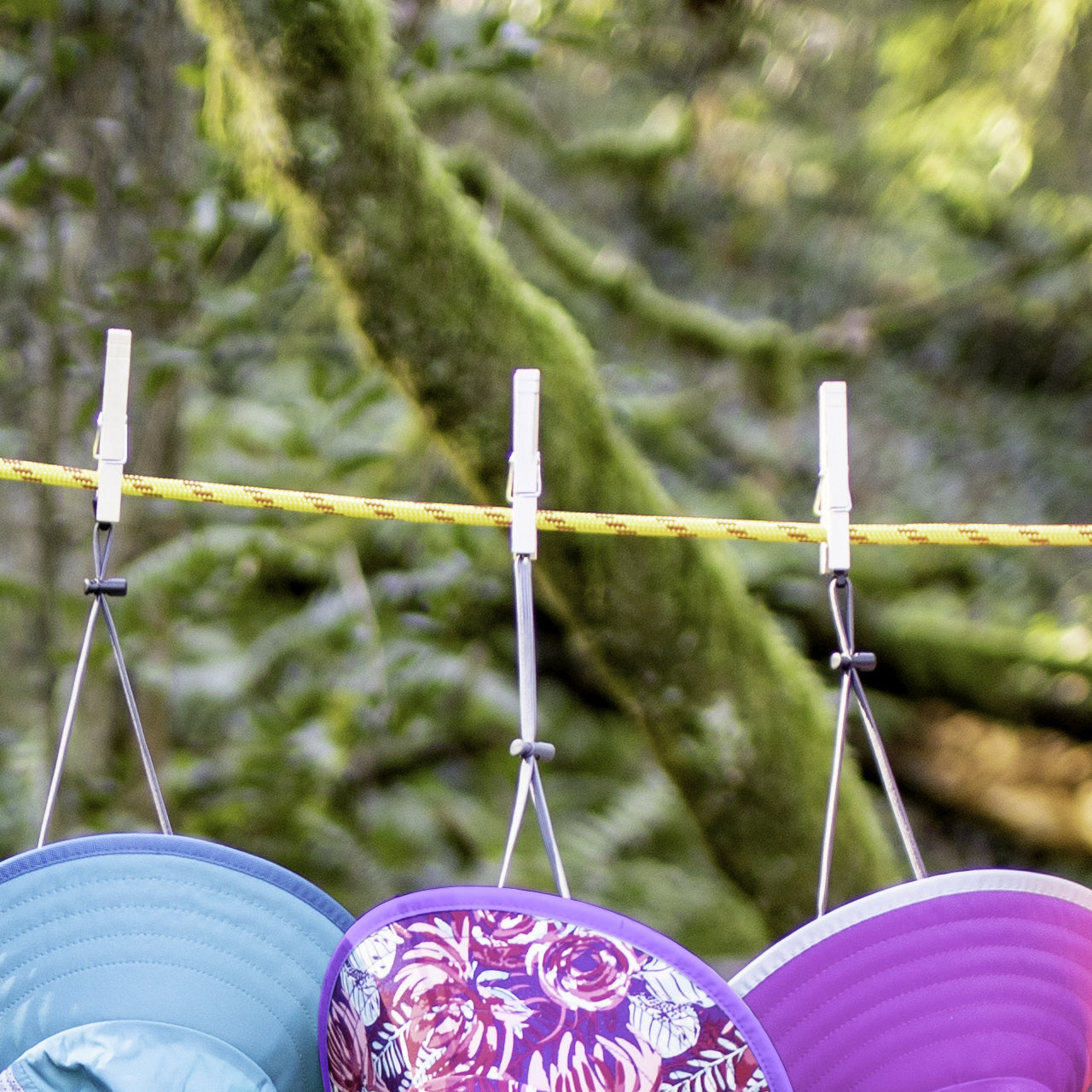 So tiny and compact, this is the perfect portable clothesline that you can take on all of your trips. Our Clothesline uses two parallel cords with rubber 'beads' that can slide along the cords. Hang the clothesline by wrapping each end around a convenient suspension point, then hook it in place. Wet items are then secured between the two cords by sliding the beads together. www.defenceqstore.com.au